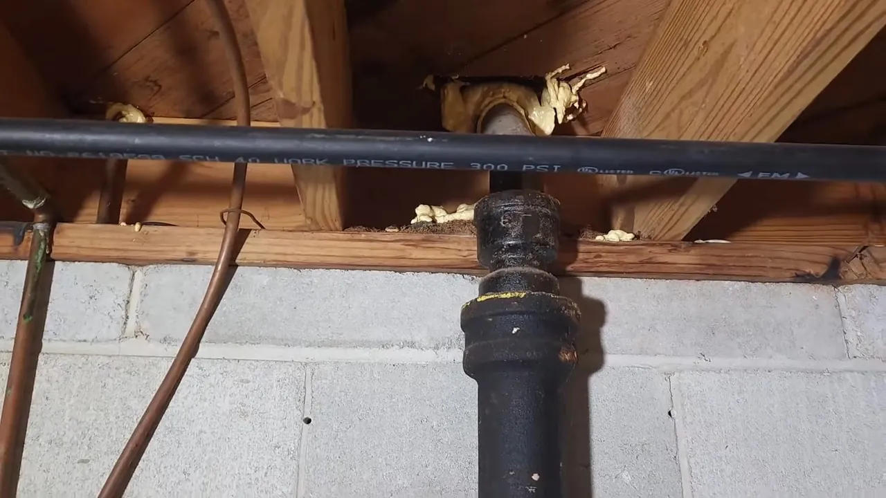 Original cast iron drain stack running through an older Berkeley basement