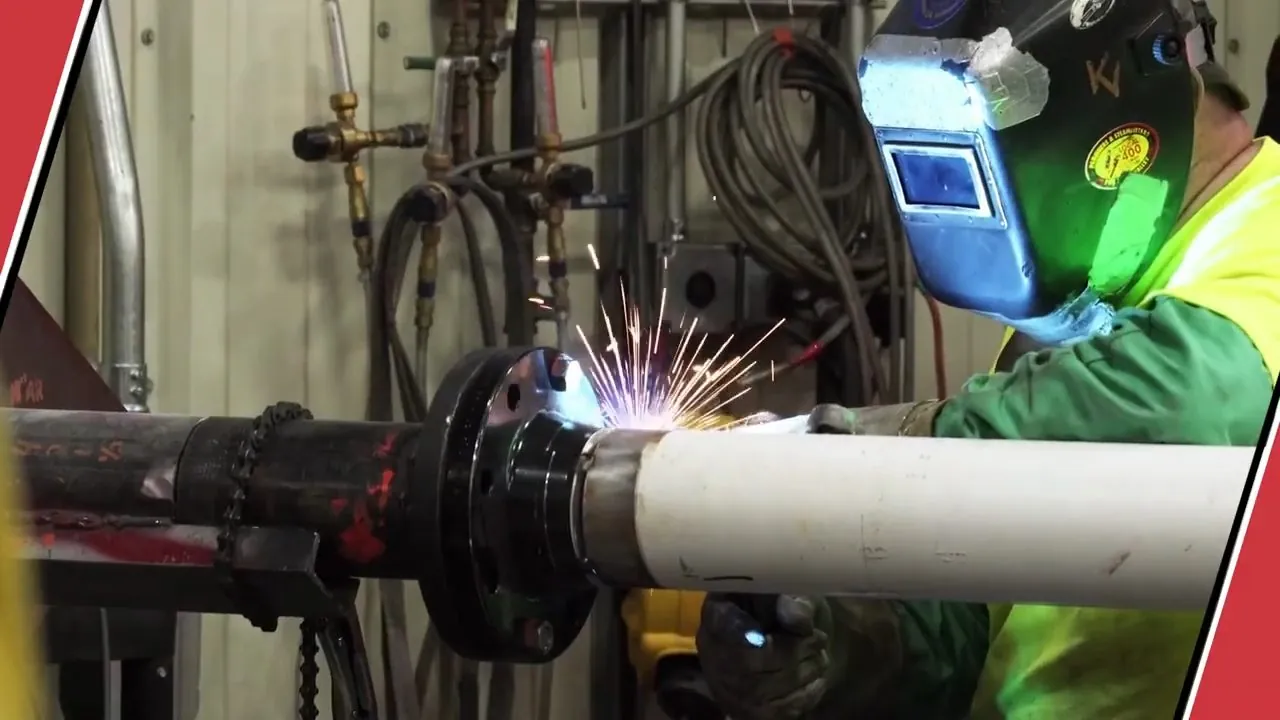 Pipefitter welding a large plumbing connection during system installation