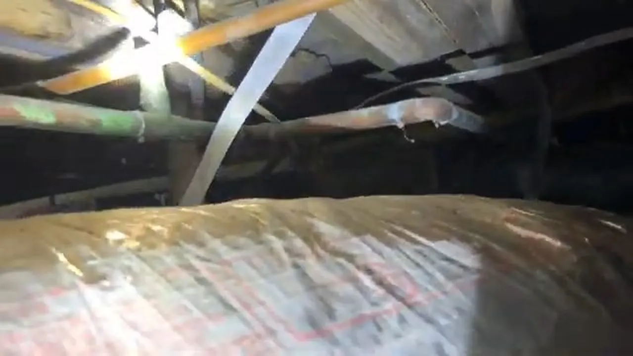 Water lines protected with insulation inside a low crawlspace