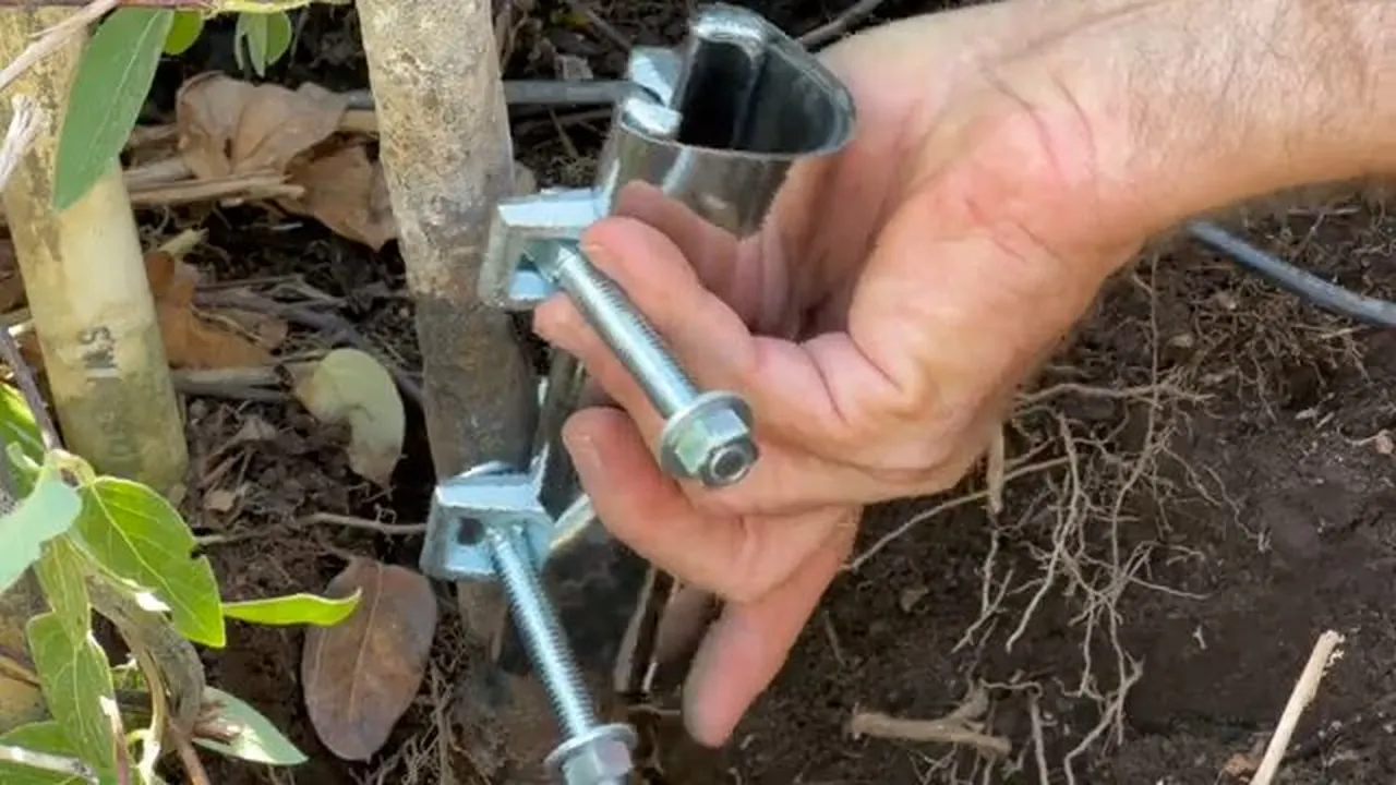 Metal sprinkler line and repair hardware exposed beside landscaping in Leppla Farms