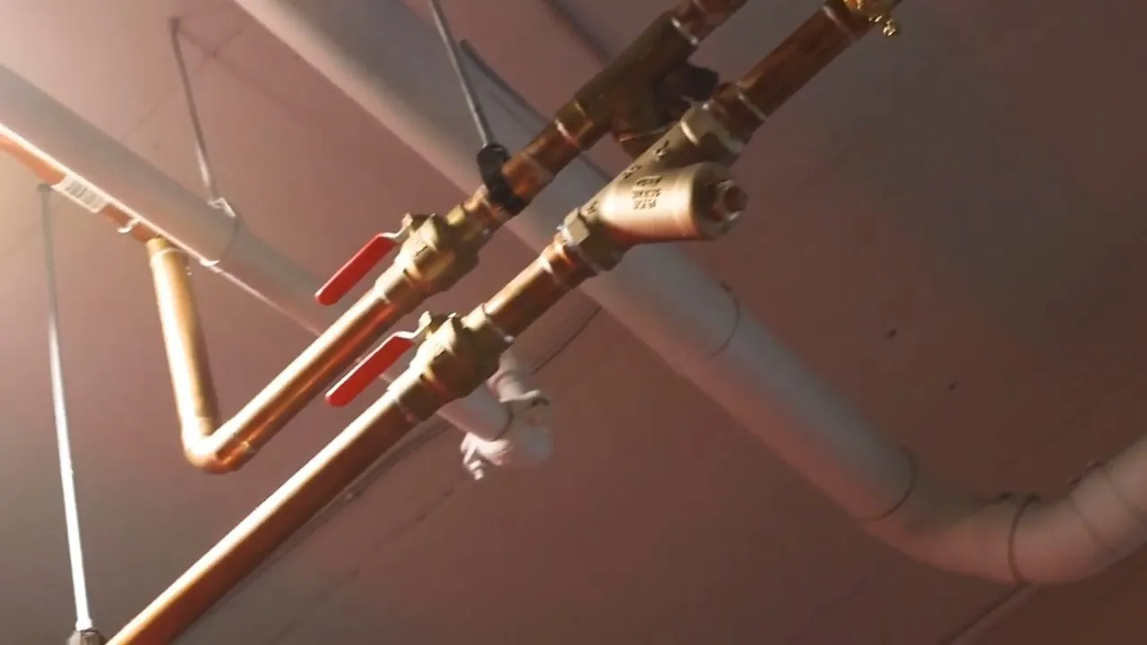 Red and blue PEX supply lines installed along exposed ceiling framing