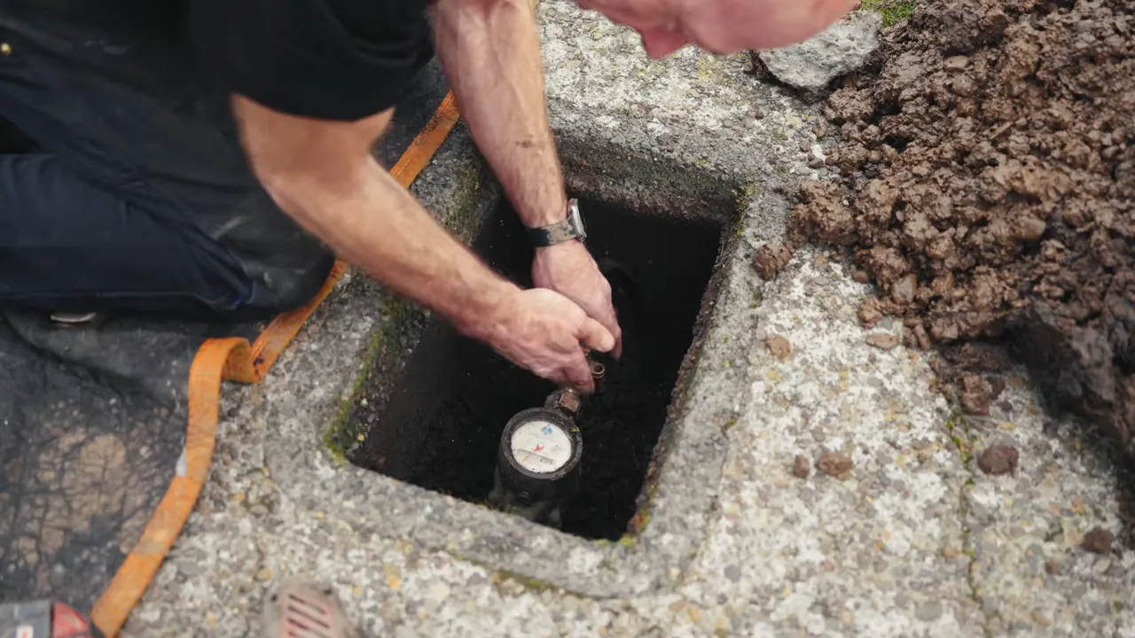 Technician accessing an underground water or sewer connection in Rolling Hills