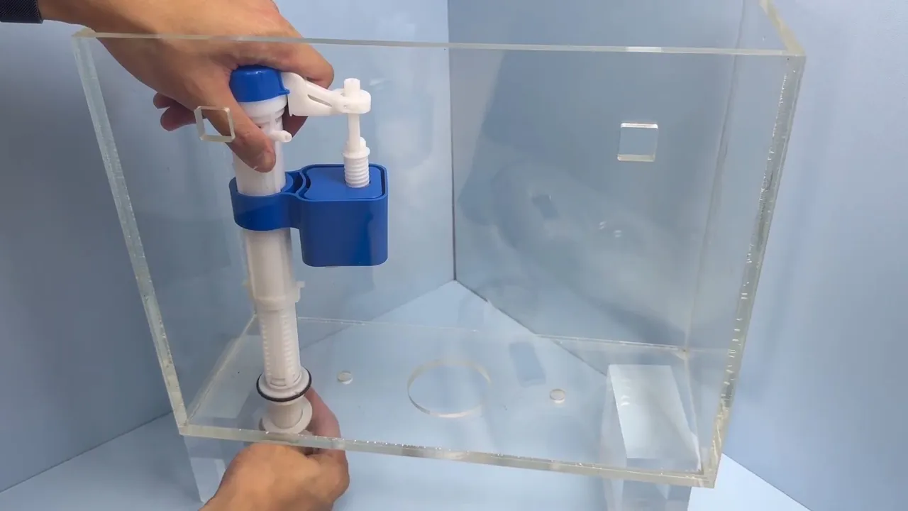 New fill valve and flush components being installed inside a toilet tank