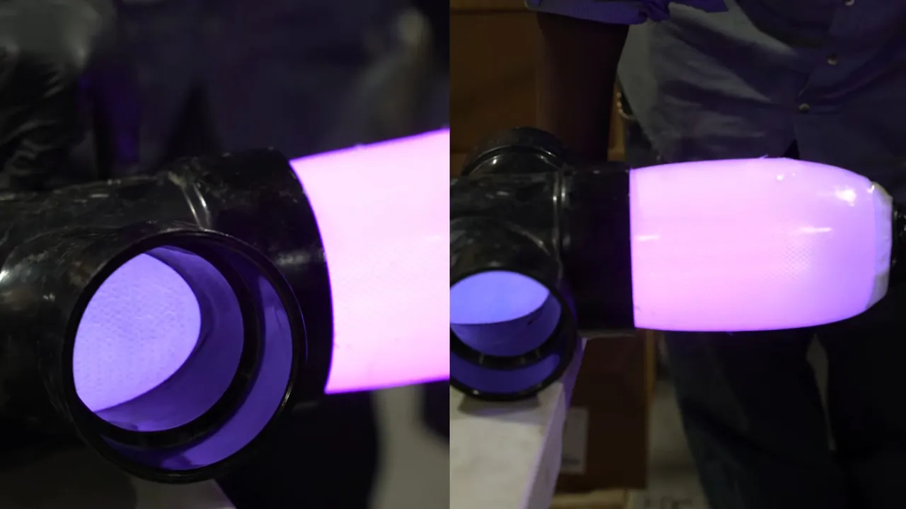 Ultraviolet curing light glowing inside a newly installed sewer liner