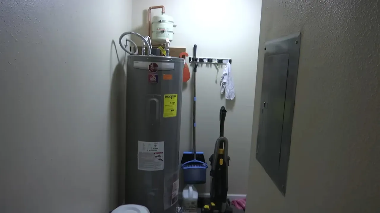 Gas water heater installed beside a furnace in a compact utility room